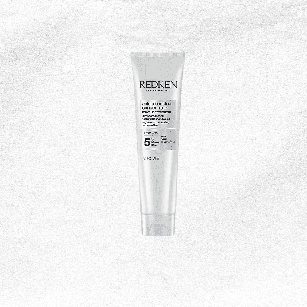 Redken Acidic Bonding Concentrate tube on a textured white background.
