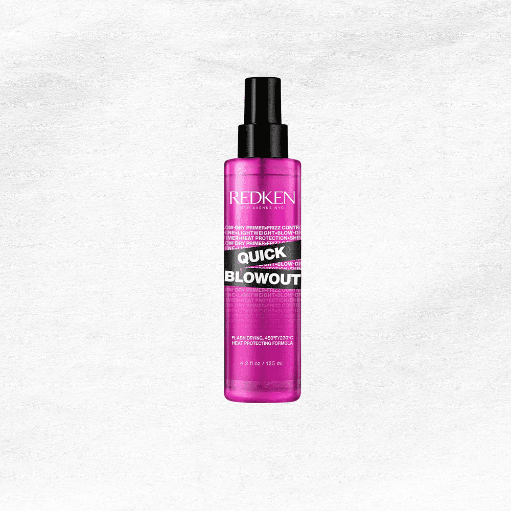 Redken Quick Blowout spray bottle with pink packaging on a textured white background.