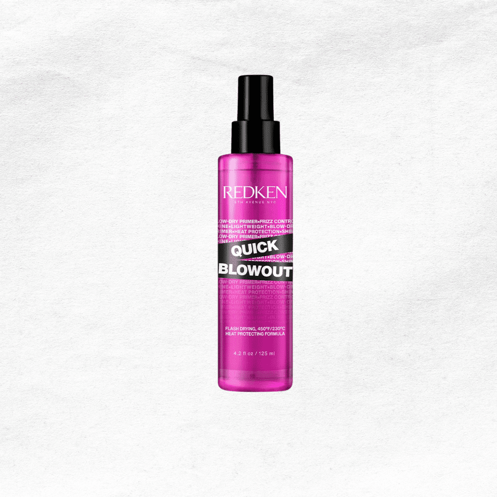 Redken Quick Blowout spray bottle with pink packaging on a textured white background.